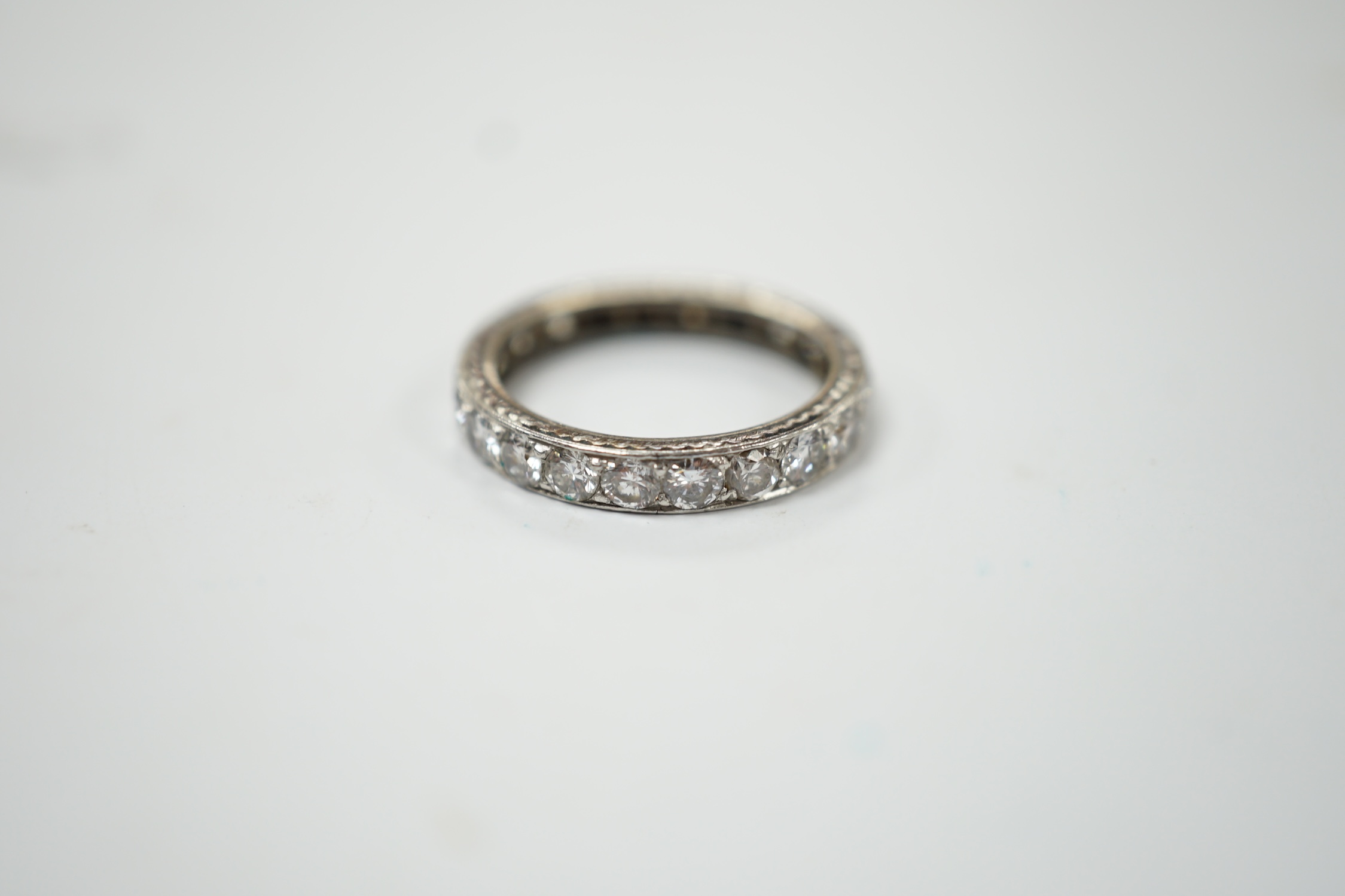 A white metal and diamond set full eternity ring, size L, gross weight 3.1 grams. Fair condition.